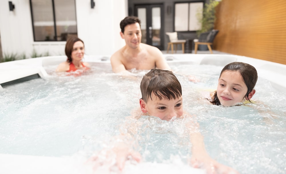 children are swimming and parents relaxing in swim spa