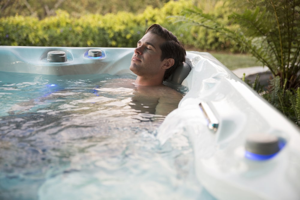 man is relaxing in hot tub spa