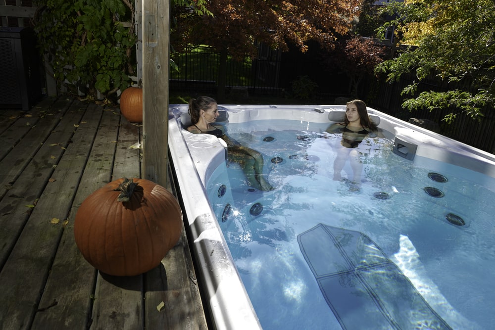 two women relaxing while doing massage in swimlife-swim spa