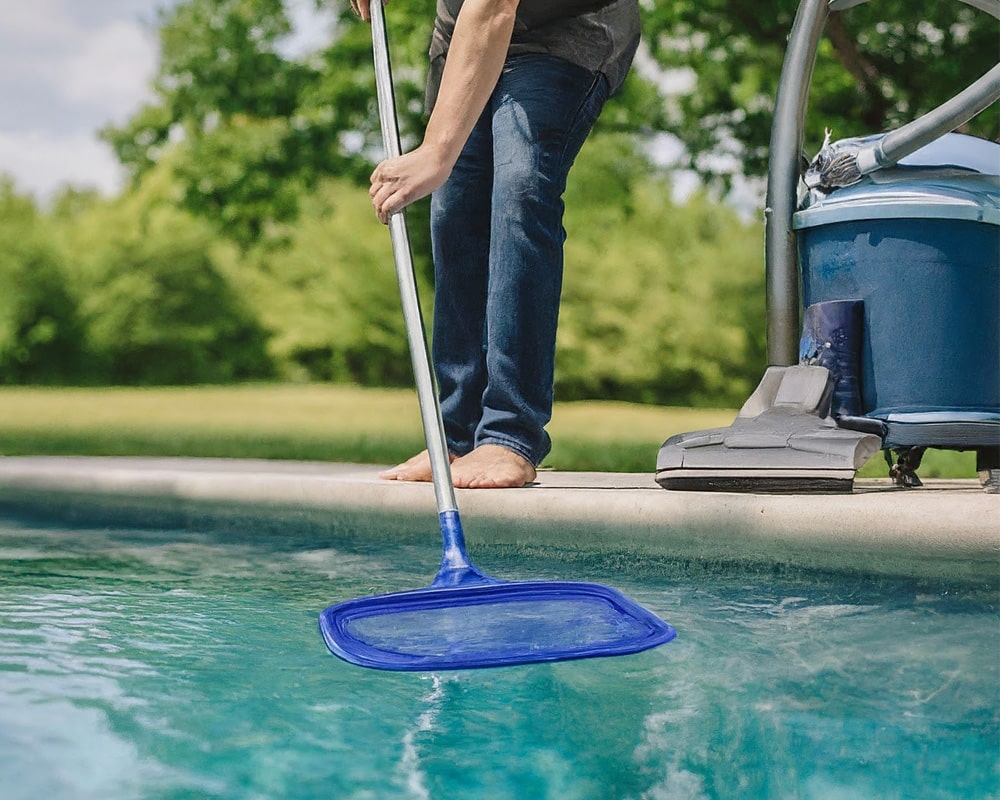 man cleaning the pool